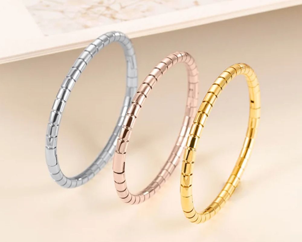 A set of gold, rose gold, and silver stretch bracelets—clean, and classic