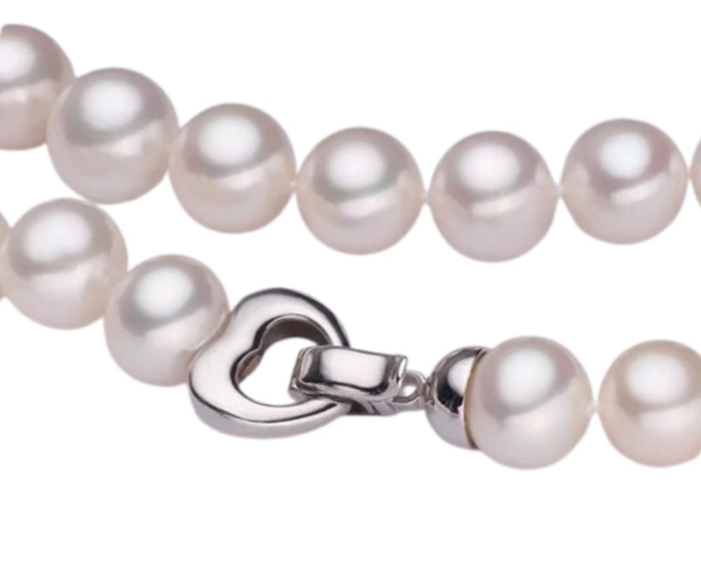 A heart-shaped toggle clasp holding together a timeless pearl bracelet